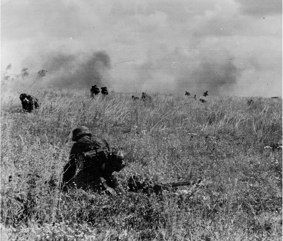  Hitlerjugend troops belonging to the infamous 12 SS-Panzer-Division HJ fight against British forces in a field