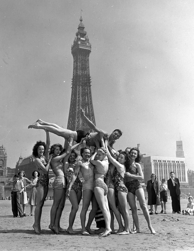  England, radio and stage stars at Blackpool as US swimmer and actor most famous for his role as Tarzan, Johnnie Weissmuller, is lifted by a group of Showgirls on the beach