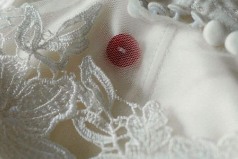  Katrice's red button was sewn into Natasha's wedding dress