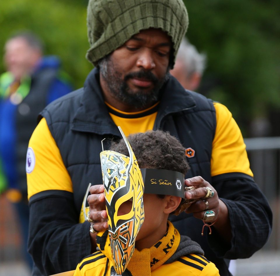 A young fan gets fitted out for the Mexican-themed day at Molineux