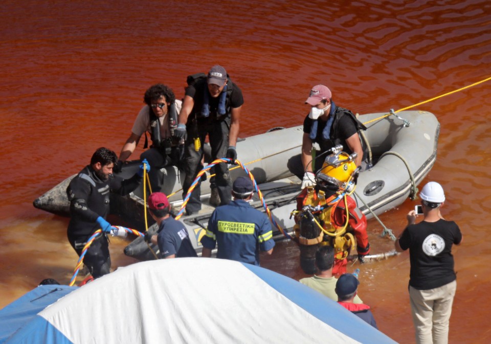  A police diver searches for a suitcase with a fifth body at the Red Lake in Mitsero village