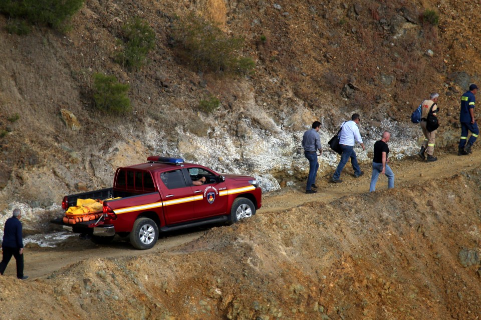  A suitcase retrieved from a man-made lake is transported on the back of a fire truck