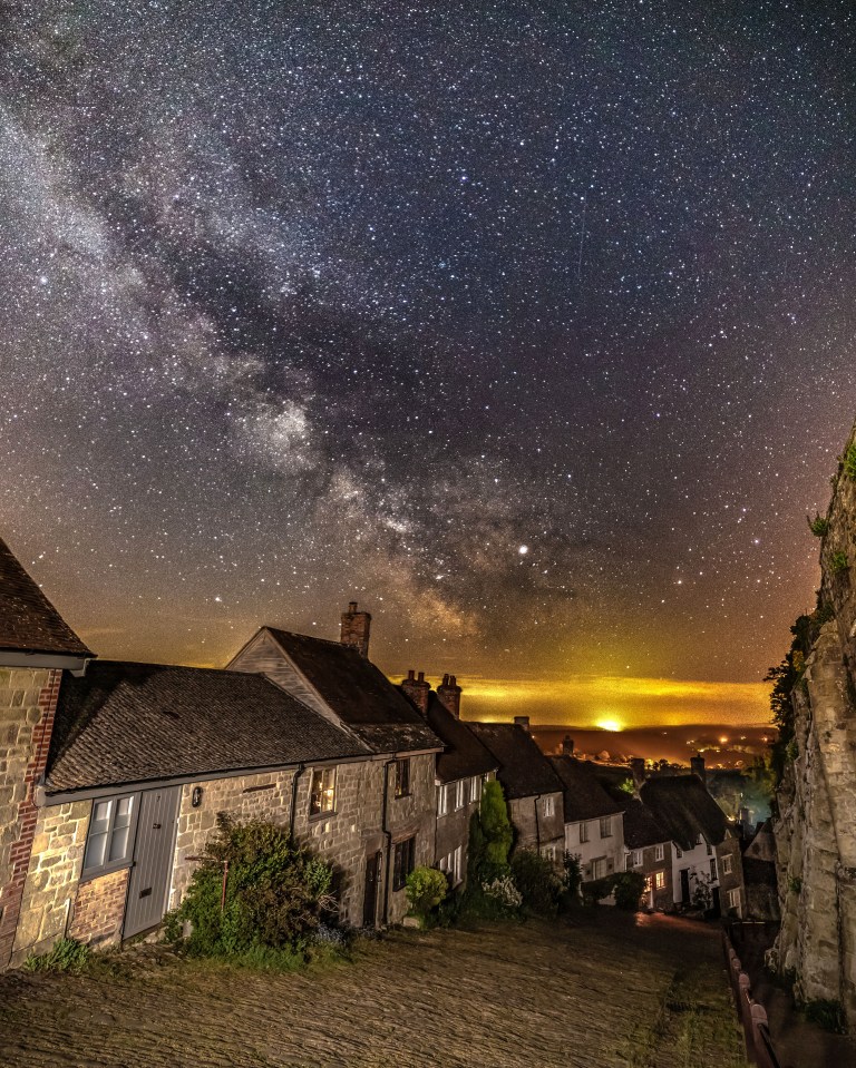  Pictured in the early hours of Monday morning, the Milky Way is seen over Gold Hill in Shaftesbury, Dorset. The cobbled street on a steep slope was made famous by the Hovis advert from the 1970's