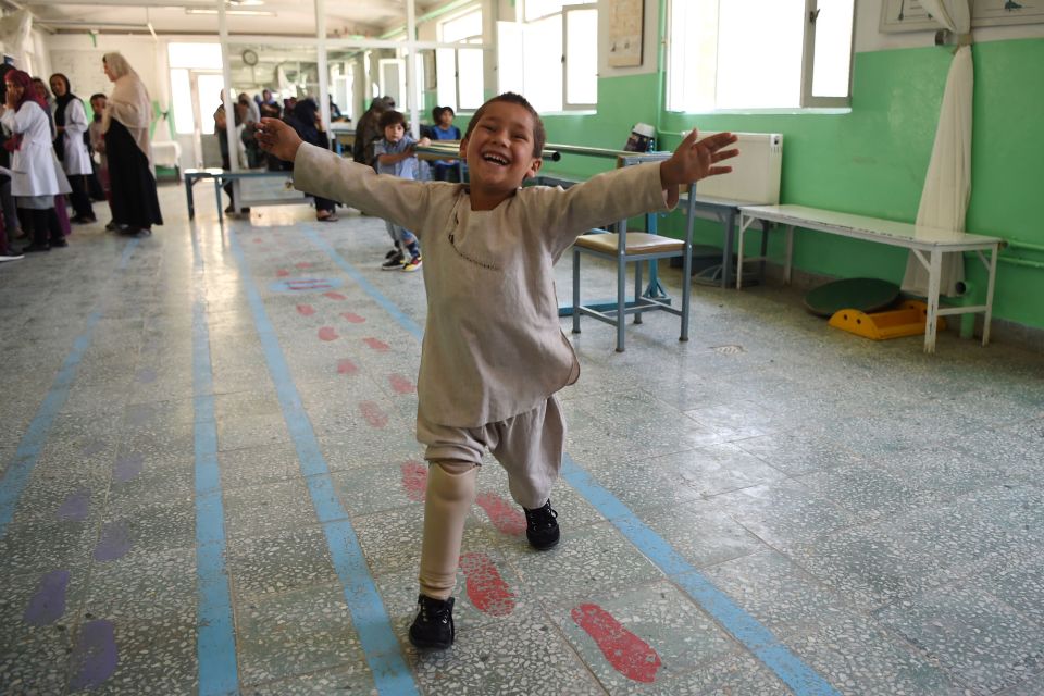  Ahmad Sayed Rahman, a five-year-old Afghan boy who lost his right leg when he was hit by a bullet in the crossfire of a battle, gestures as he dances with his prosthetic leg at the International Committee of the Red Cross hospital for war victims and the disabled, in Kabul on May 7