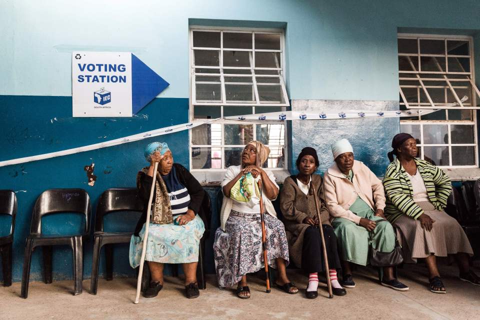  South African people sit in a queue to cast their vote during the sixth general election at the Cottanlands Primary school 45 kilometres north of Durban. South Africans began voting today in national elections which the ruling ANC, in power since 1994, is favourite to win despite corruption scandals, sluggish economic growth and record unemployment