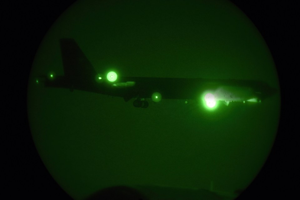  Seen through night vision, one of the B-52 bombers ordered by the White House to deploy to the Persian Gulf to counter unspecified threats from Iran arrives at a major American air base in Qatar