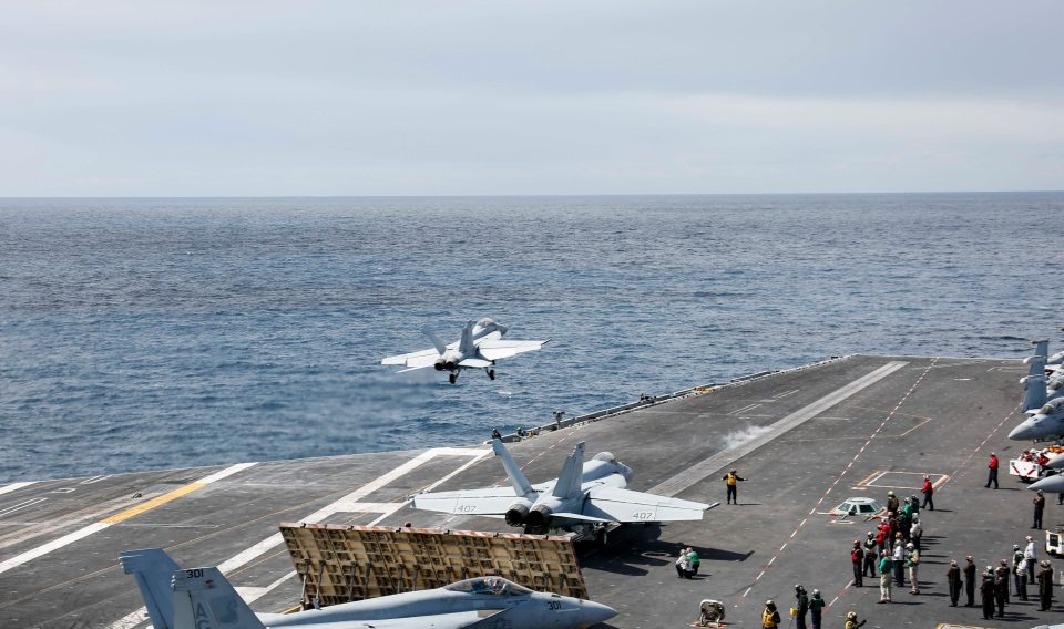  F/A-18F Super Hornet from the 'Jolly Rogers' of Strike Fighter Squadron (VFA) 103 launching off the flight deck of the Nimitz-class aircraft carrier USS Abraham Lincoln