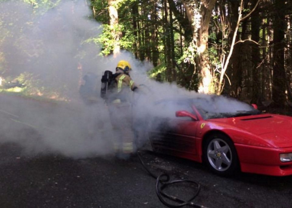  The vintage Ferrari Testarossa has massive plumes of smock billowing out of it