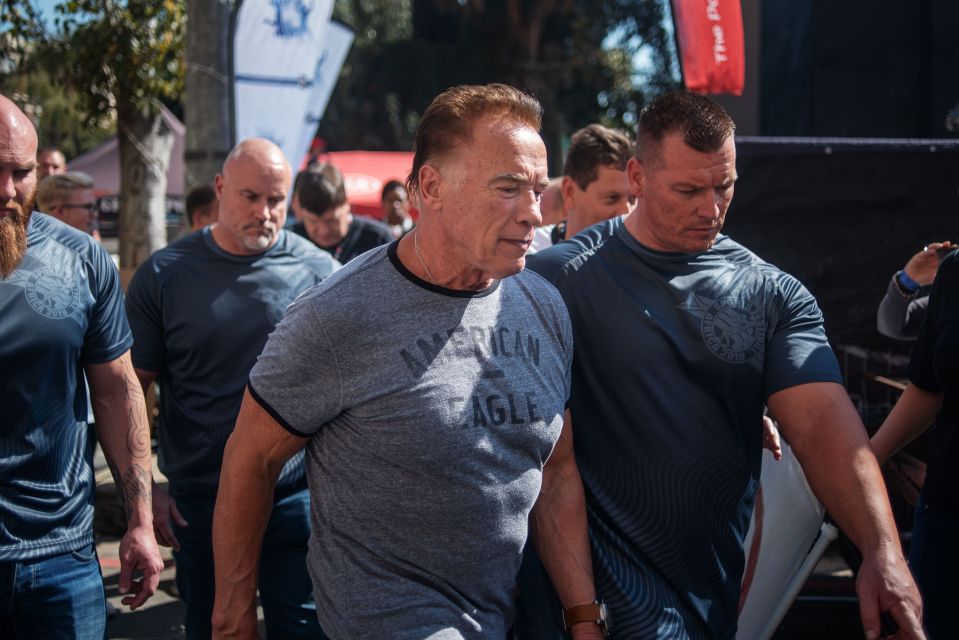  Arnie was escorted into the venue by a team of minders