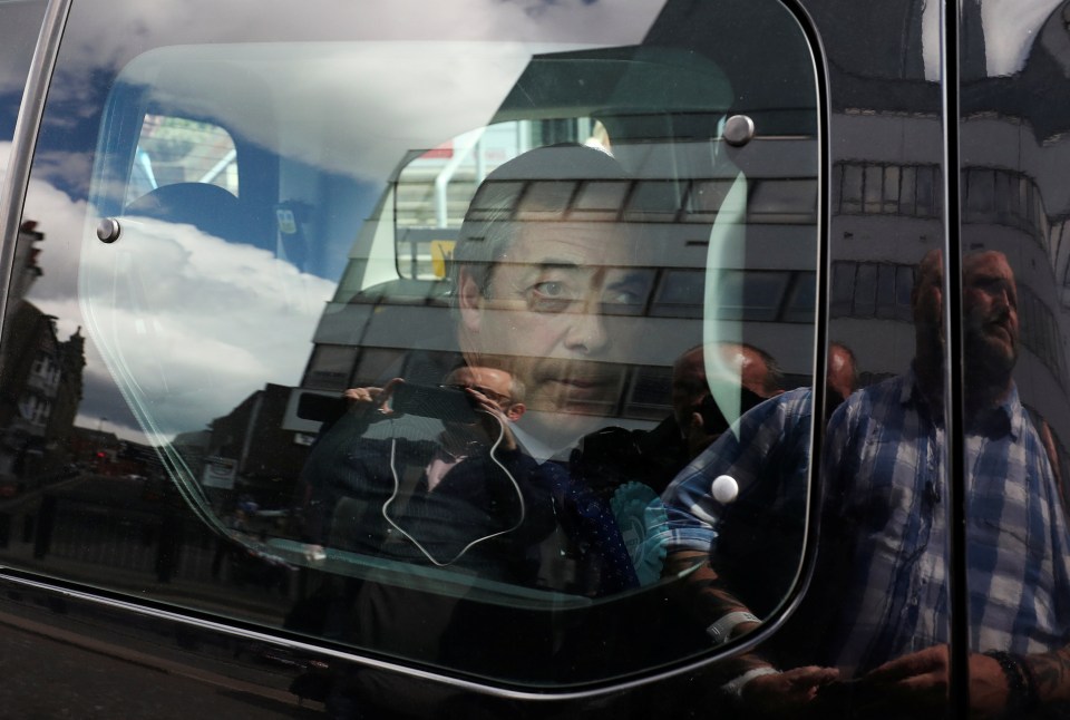  Farage was seen looking out the car window as he was whisked from the scene