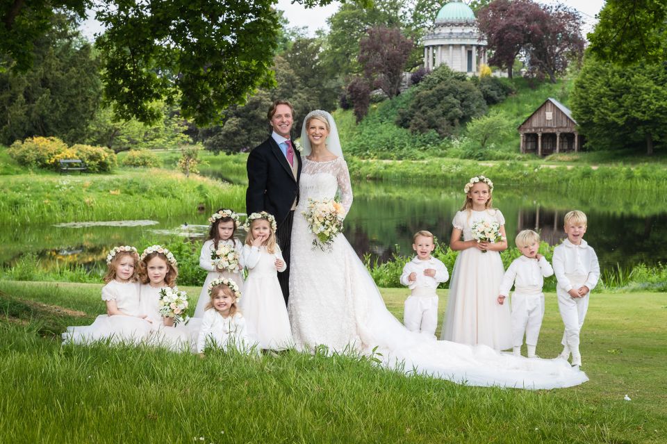 The couple pose with their flower girls and page boys in the sweet wedding photo