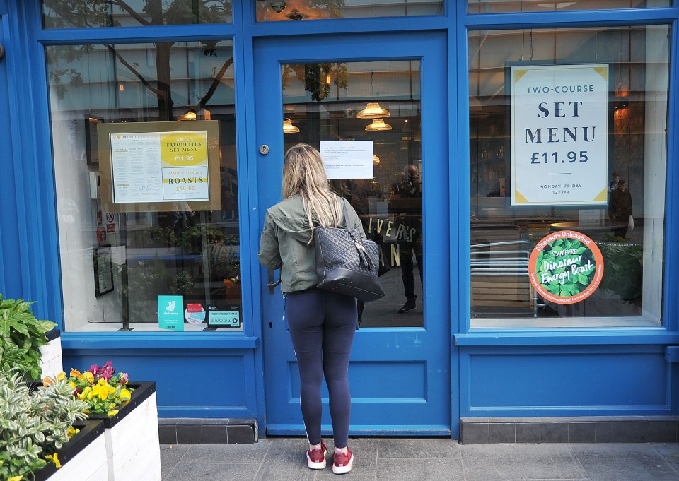  A member of staff at Jamie's Italian in Liverpool reads a notice of the restaurant's closure