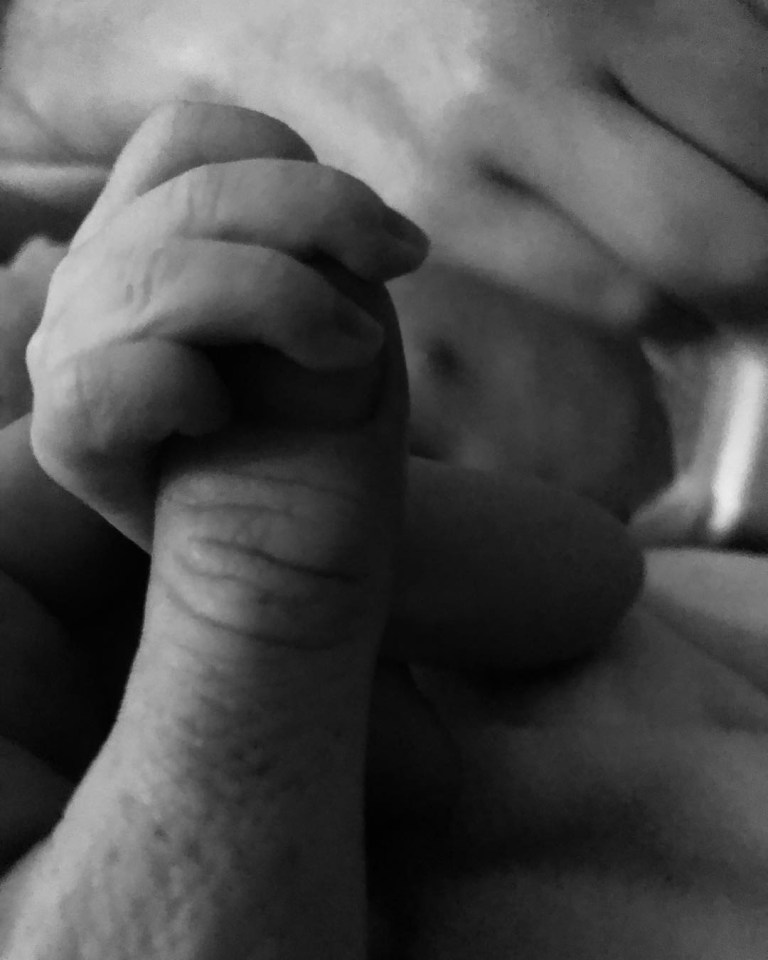  Joe Swash holding hands with his newborn