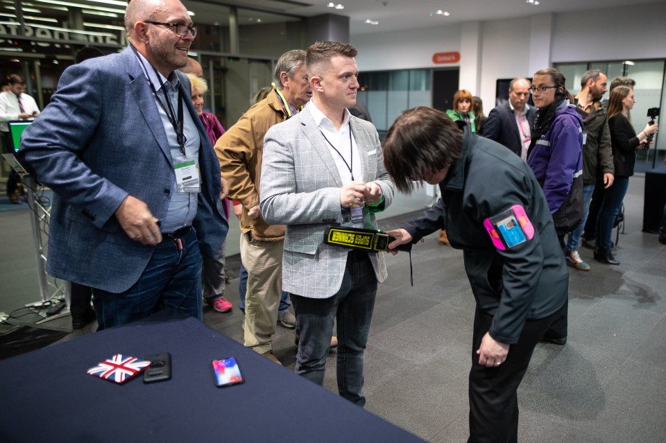  Robinson is checked on his way into the counting hall in Manchester