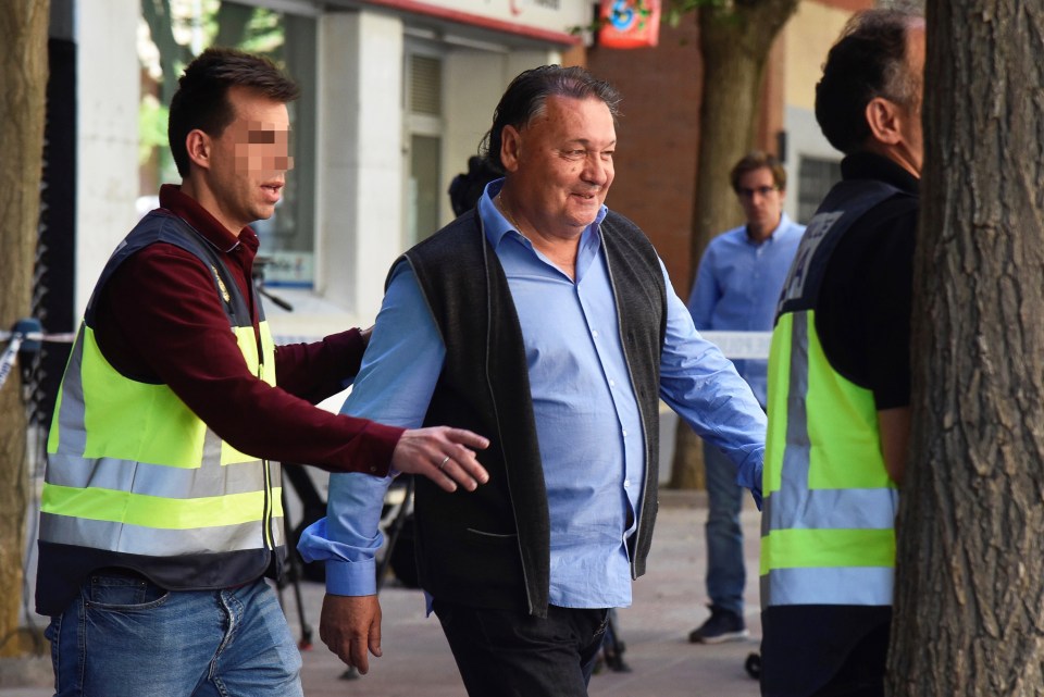 Huesca president Agustin Lasaosa is escorted by police after being arrested