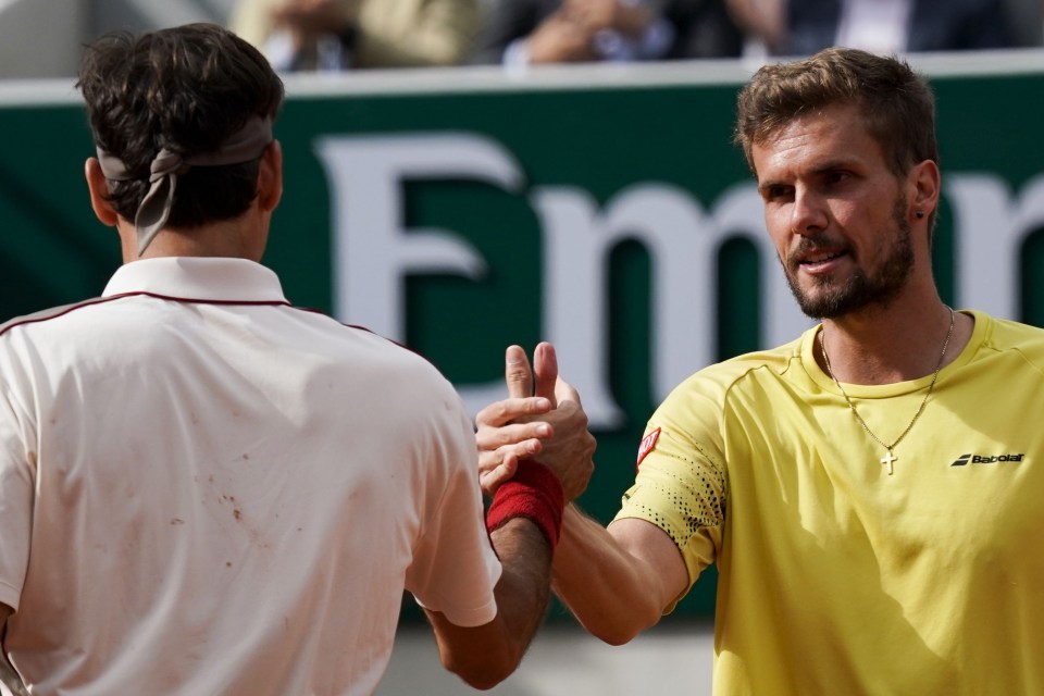 Roger Federer is congratulated by Oscar Otte after his victory