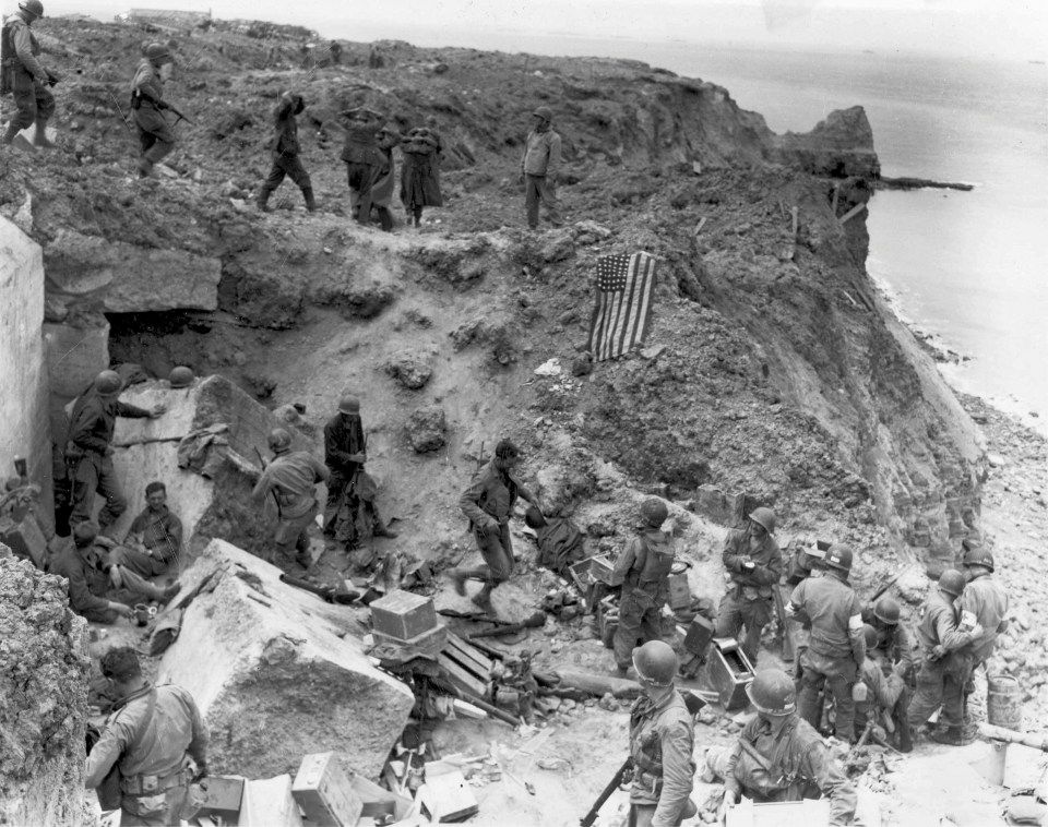  An American flag lies as a marker on a destroyed bunker two days after the strategic site overlooking D-Day beaches was captured