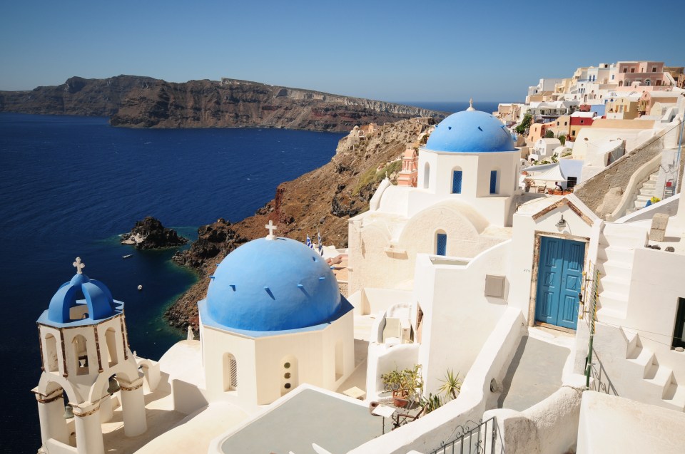 See white-washed villages, blue-domed churches and beautiful sunsets in Santorini, one of the Cyclades Islands