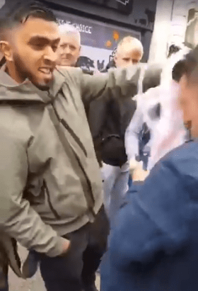  A lad hurls milkshake over Tommy Robinson in Warrington