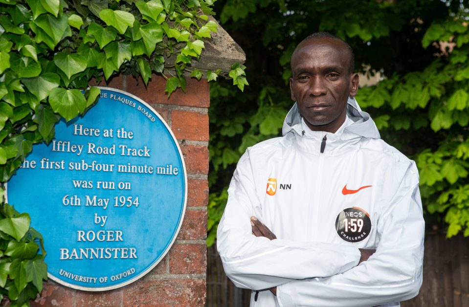  The Kenyan poses next to the Roger Bannister memorial plaque in Oxford as his challenge is announced on the 65th anniversary of the four-minute-mile being broken