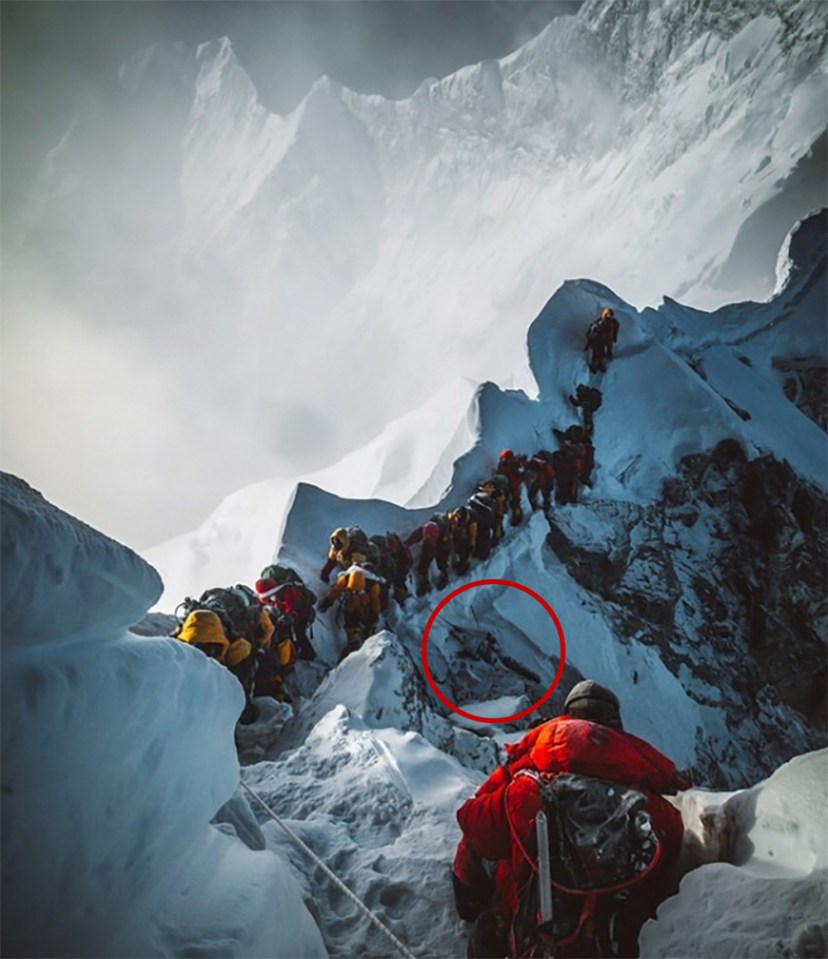  A distressing photo shows climbers queuing past a frozen dead body on Mount Everest