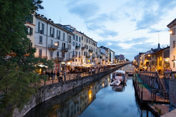 a row of buildings along a river with a sign that says ' ristorante ' on it