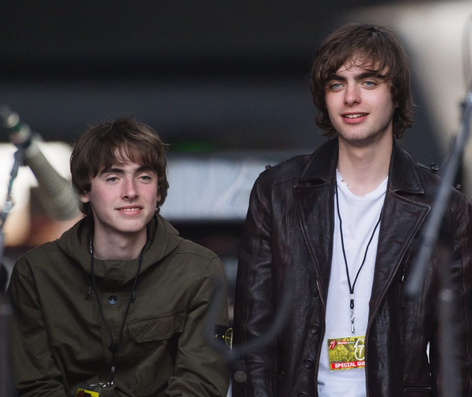 Gene and Lennon Gallagher watch their father Liam Gallagher perform live on stage in 2018 