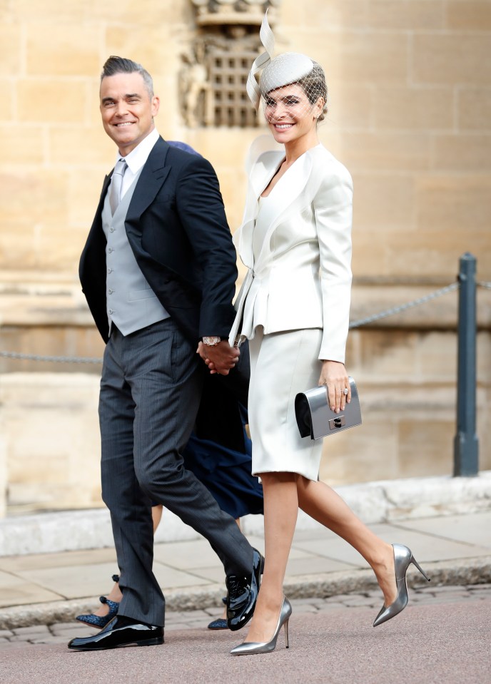  Robbie Williams and his wife Ayda Field at Princess Eugenies wedding last year. The star was reportedly barred from receiving an OBE this year