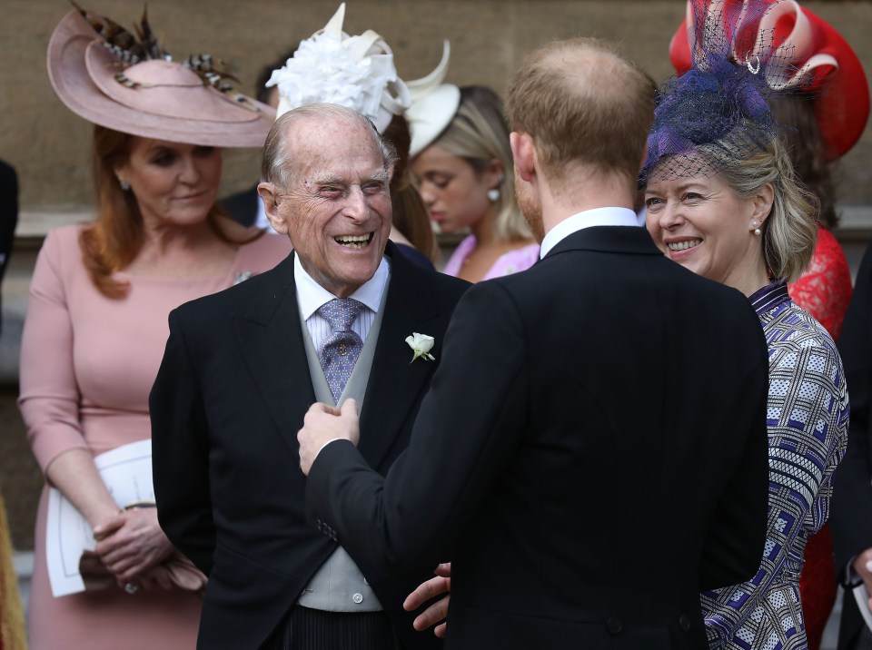 Prince Philip and Prince Harry chat together after the wedding ceremony of Lady Gabriella Windsor and Thomas Kingston