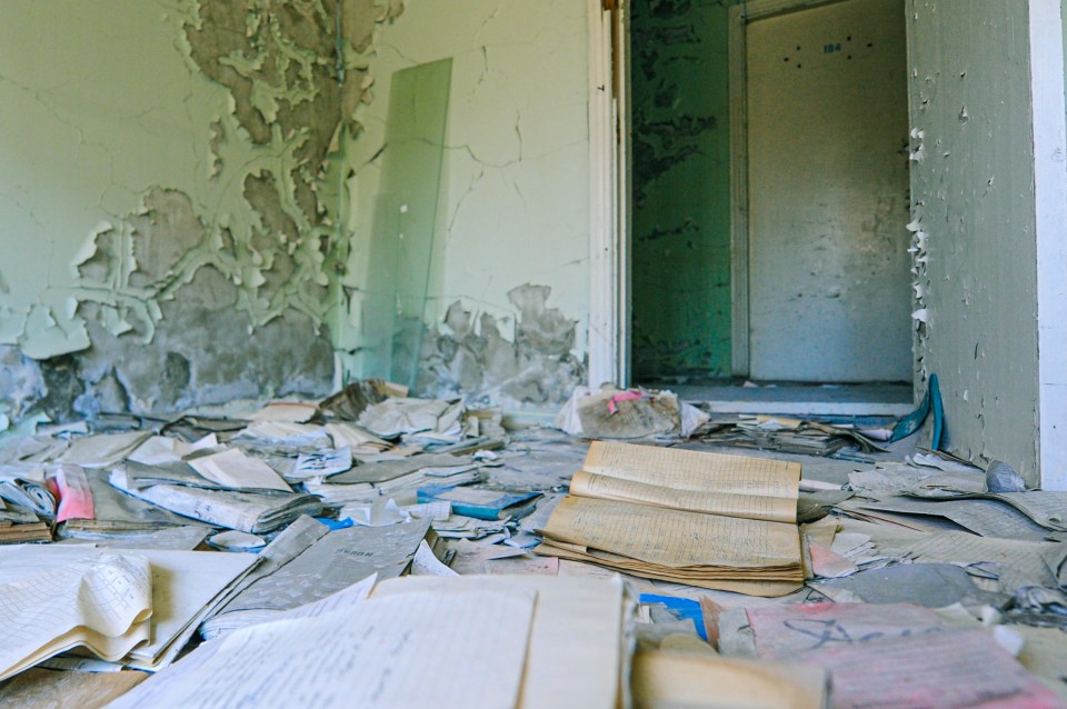  Books line the floors of an eerily quiet and abandoned former school