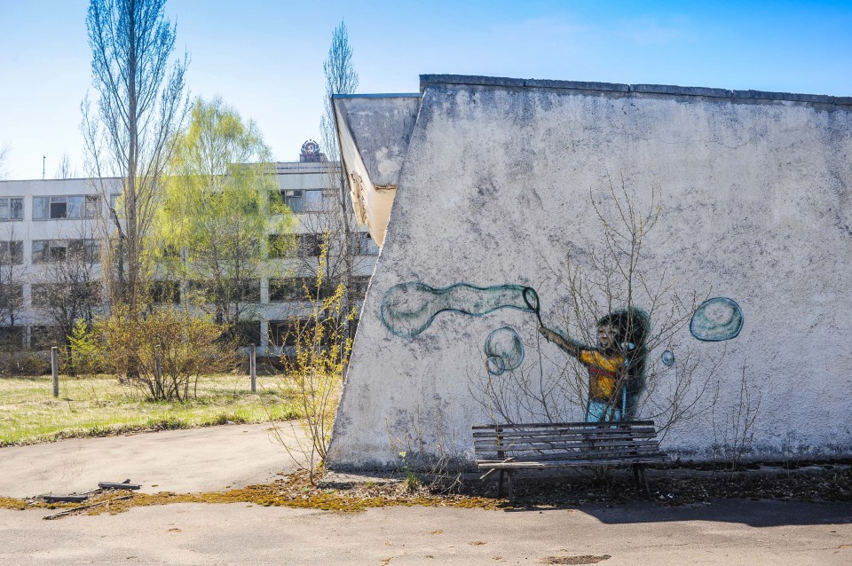  A painting of a child on the side of a building in sunny Pripyat, where the disaster occurred