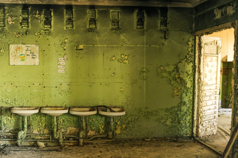  A bathroom in an abandoned school in Pripyat