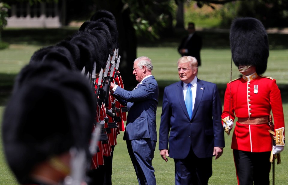  Prince Charles adjusting a Guardsman's uniform