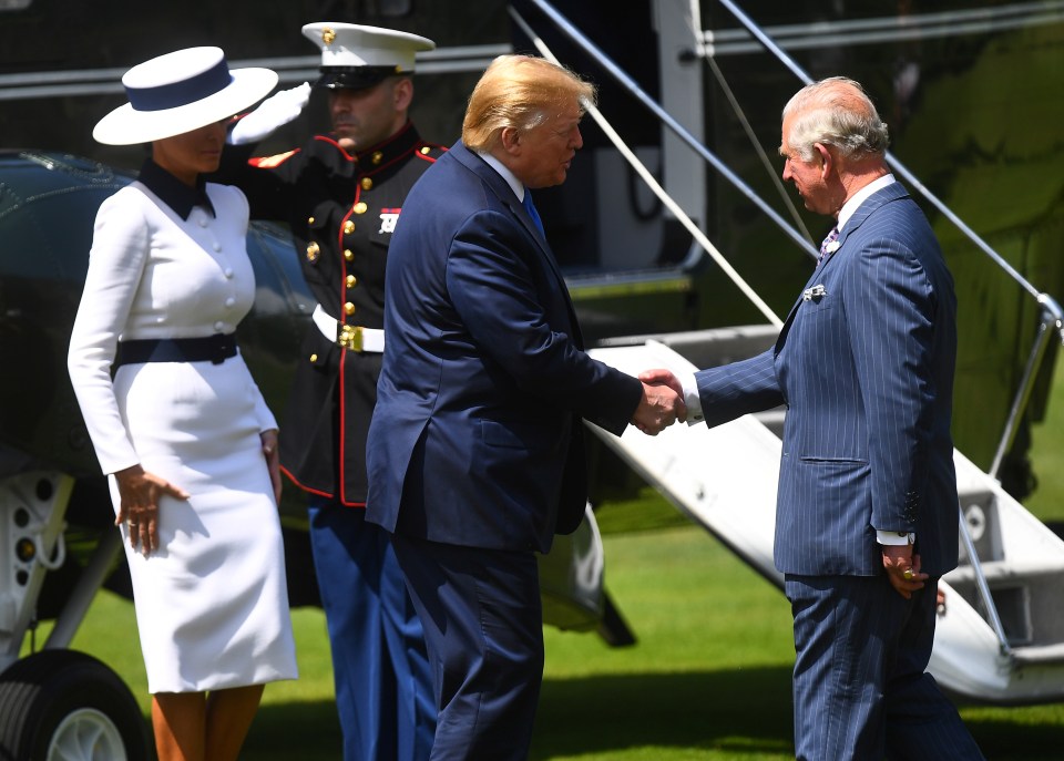  Mr Trump grasped Prince Charles' hand as he greeted him today