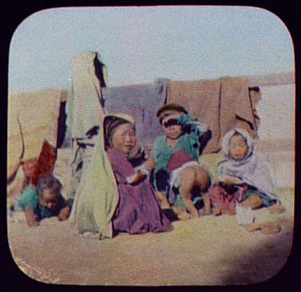  A group of small children sit in the midday sun