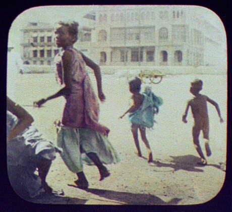  A mother plays in front of the camera with her two children