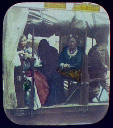  A woman in a train carriage. A sign above reads 'Native females' and 'Third class'.