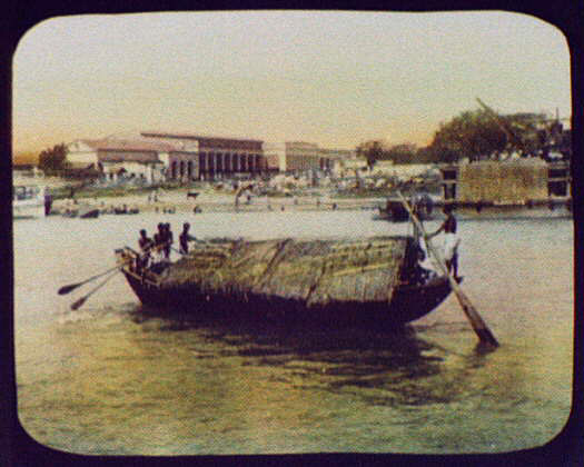  Workers row a thatch-roofed boat