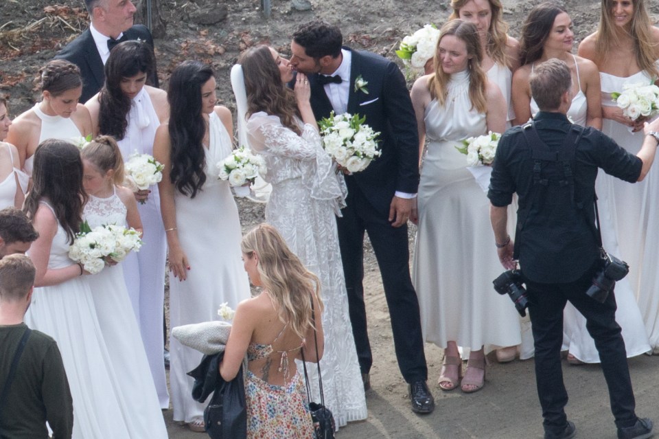 They later posed with the wedding party for more pics