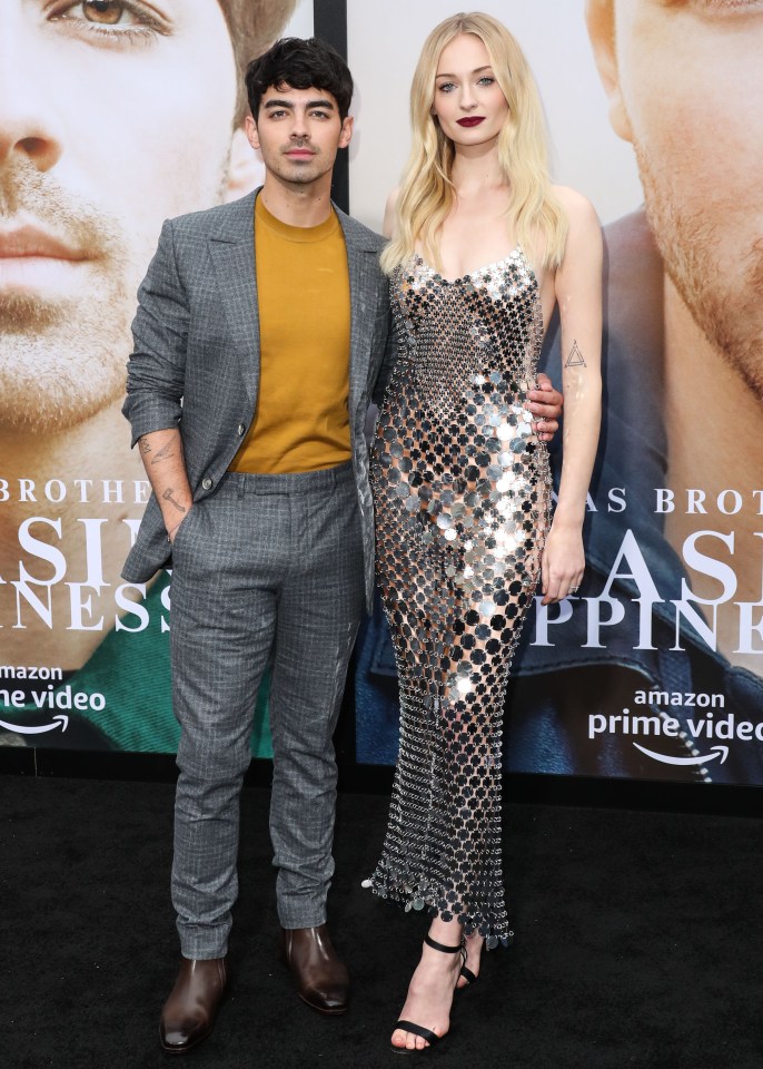  Joe Jonas with Games Of Thrones actress Sophie Turner wearing a silver dress