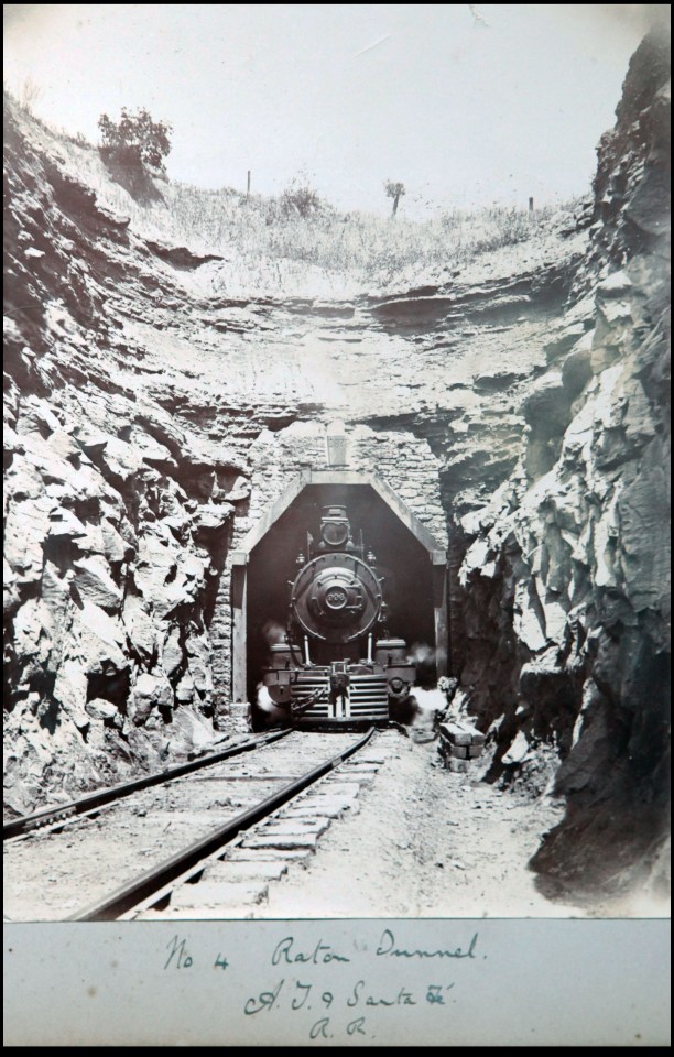  A locomotive train emerges from a tunnel near Raton on the Santa Fe railroad