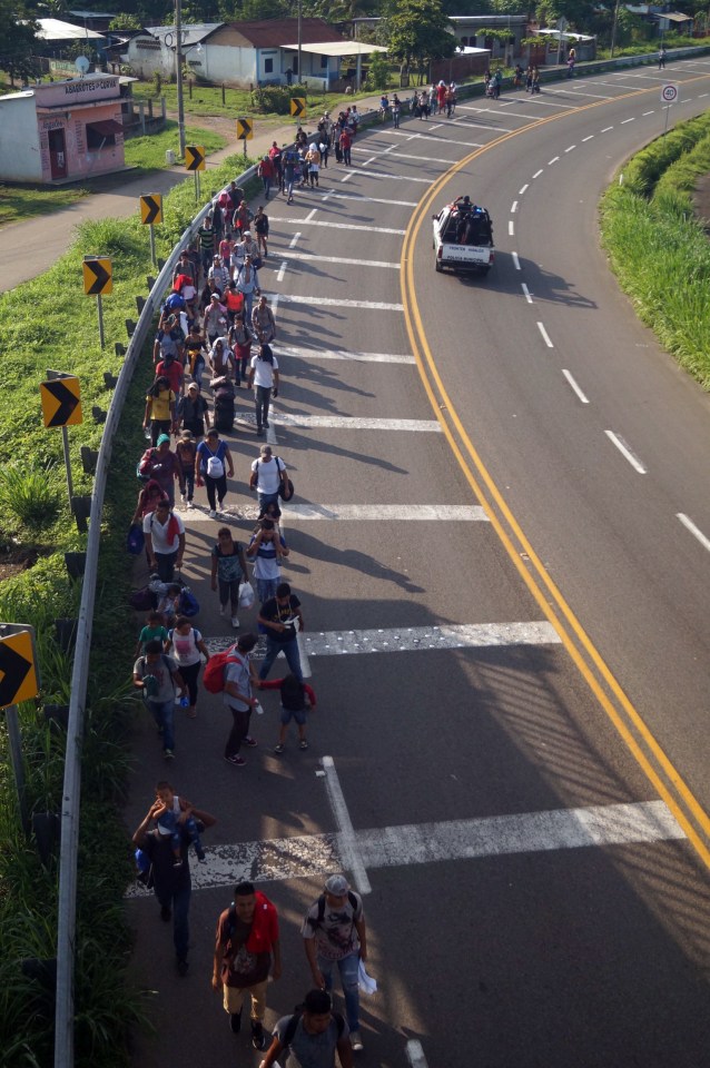  Migrants walk towards a road heading to the Mexican city of Tapachula after crossing the Guatemala border