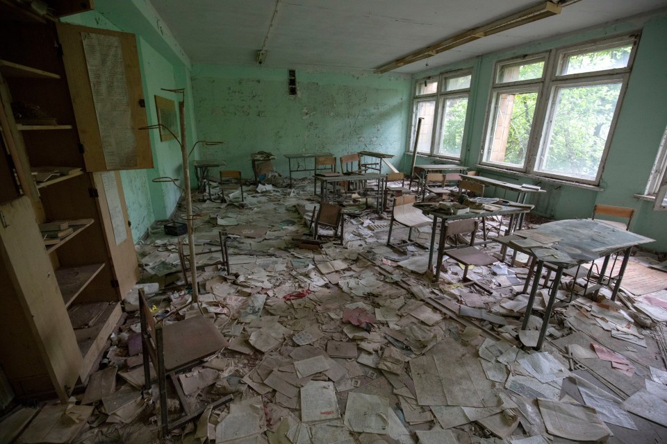  The trip includes a stop at a derelict school filled with crumbling desks still strewn with exercise books