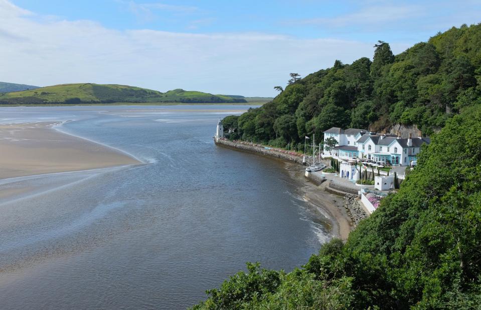  The soft sand beach is tucked into the cliffs