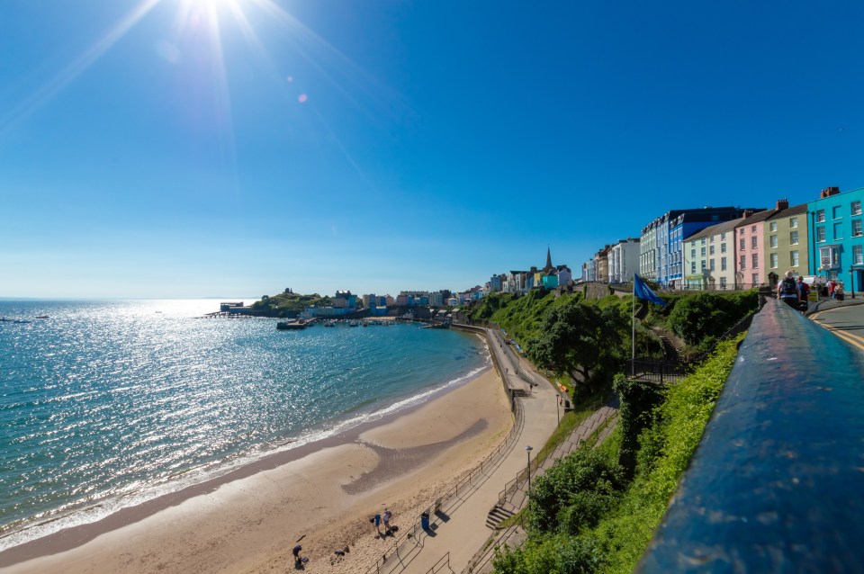  The beach extends underneath the house-lined cliff