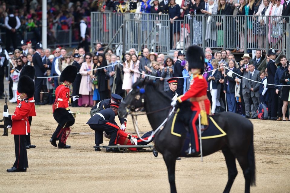  Medics placed the fallen soldier on a stretcher and took him away during the ceremony celebrating the Queen's official birthday