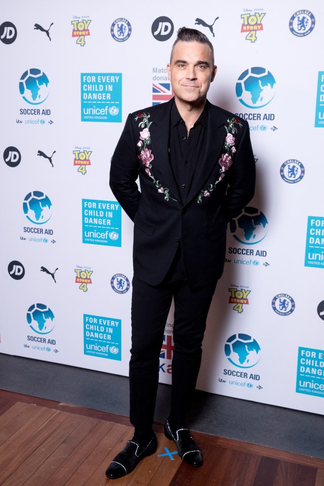  Robbie William stood out in an embroidered blazer