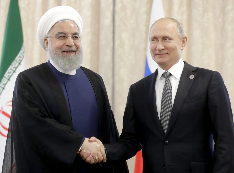  Rouhani shakes hands with Russian President Vladimir Putin at the Shanghai Cooperation Organization (SCO) summit in Kyrgyzstan