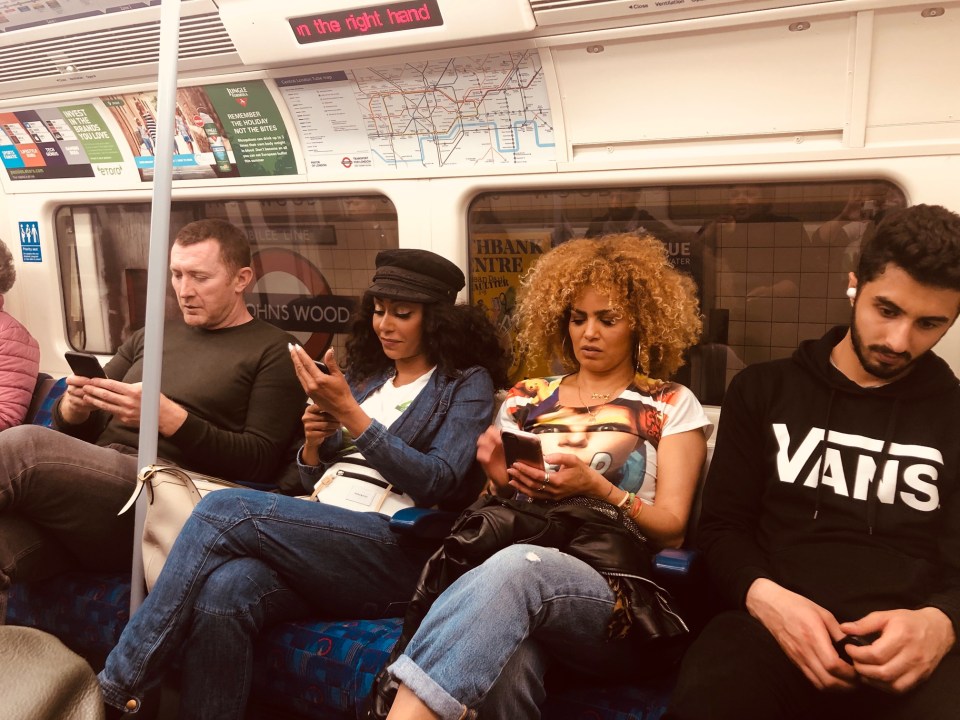  Shocked passengers can be seen holding up their phones to take pictures of the star in the reflected window