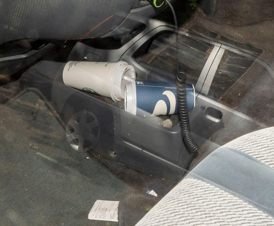  Takeaway coffee cups in the holder and receipts on the floor